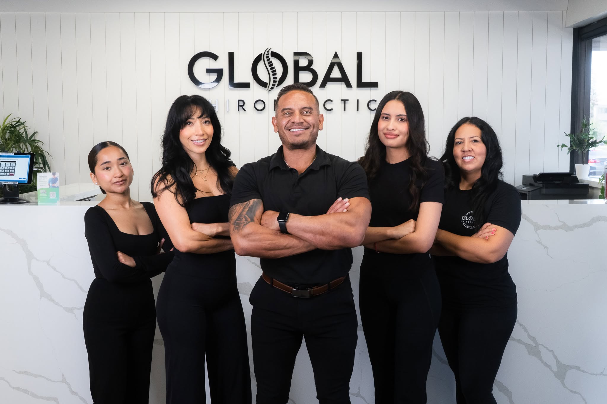 Dr. Steve and the Global Chiropractic team at the front desk in Tempe